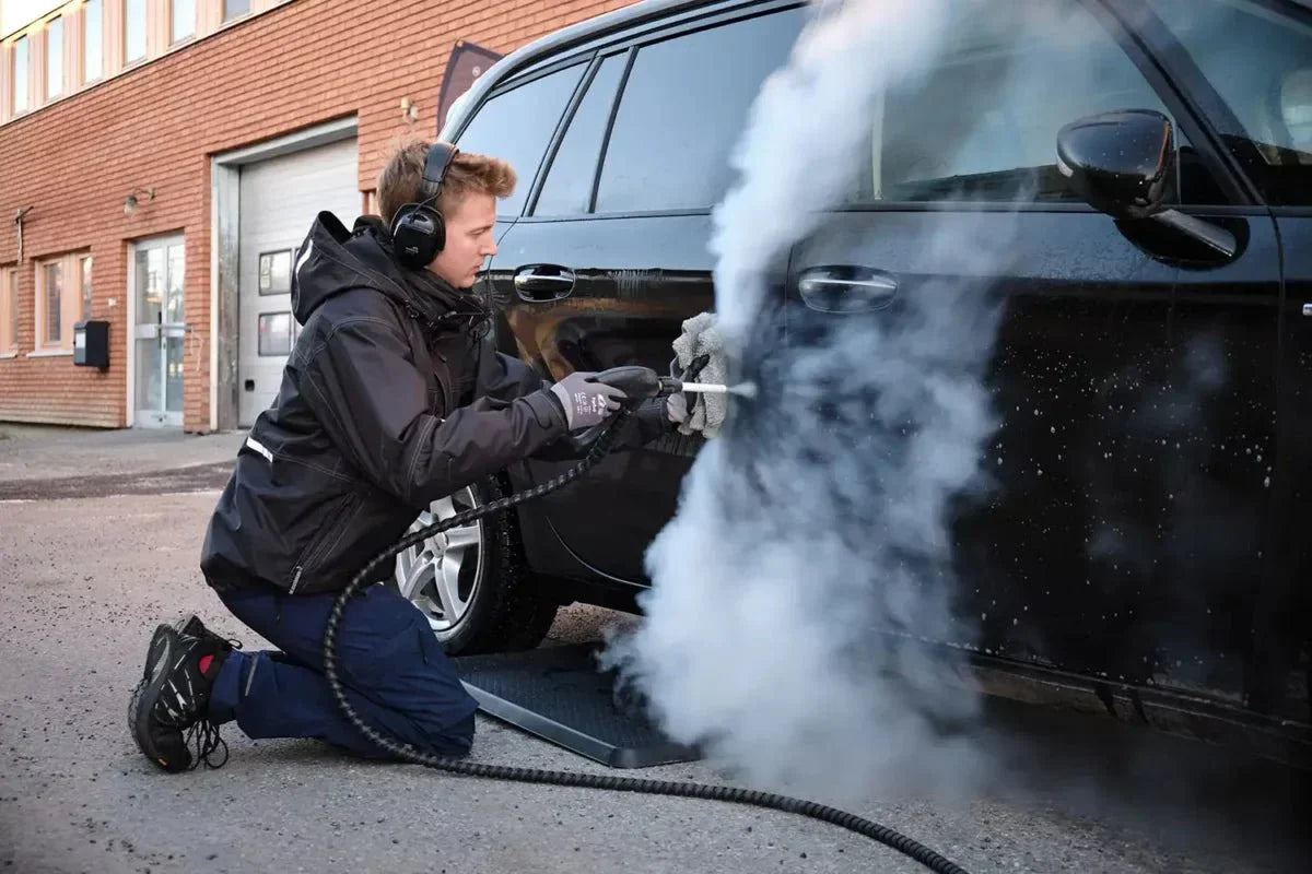 BOSS BOYS steam cleaner in action cleaning car engine bay with superheated steam
